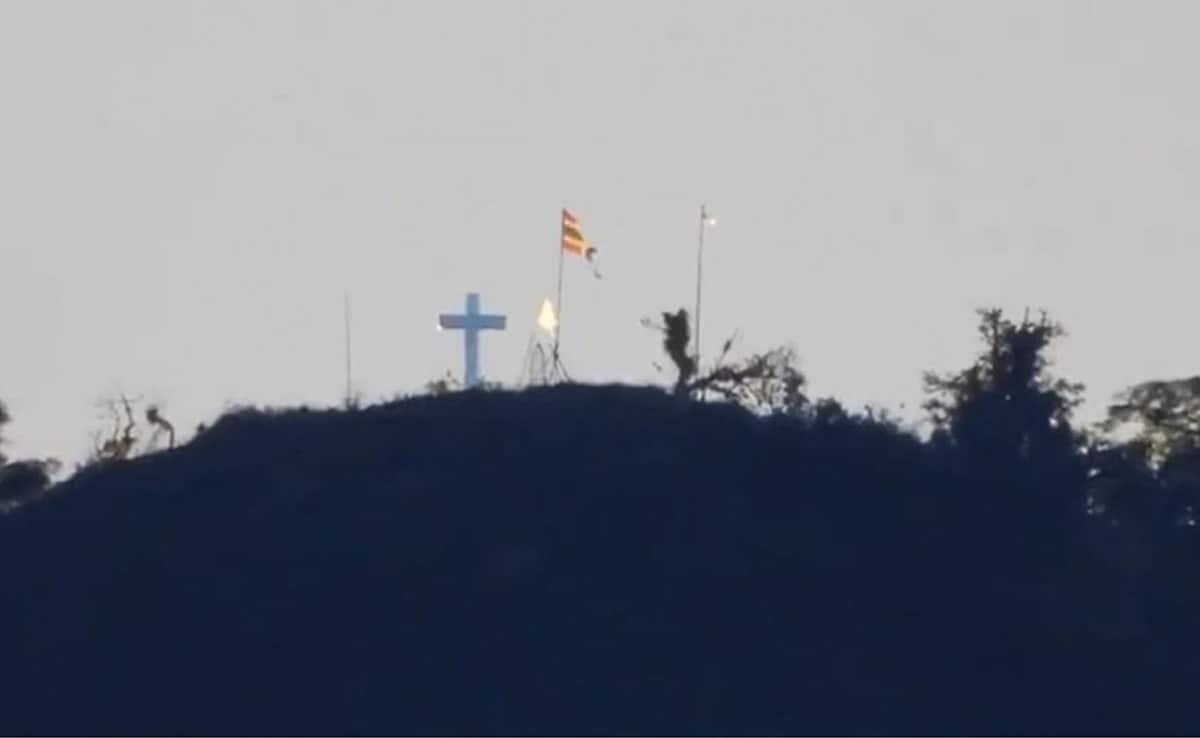Row Over Cross And Flag Atop Manipur